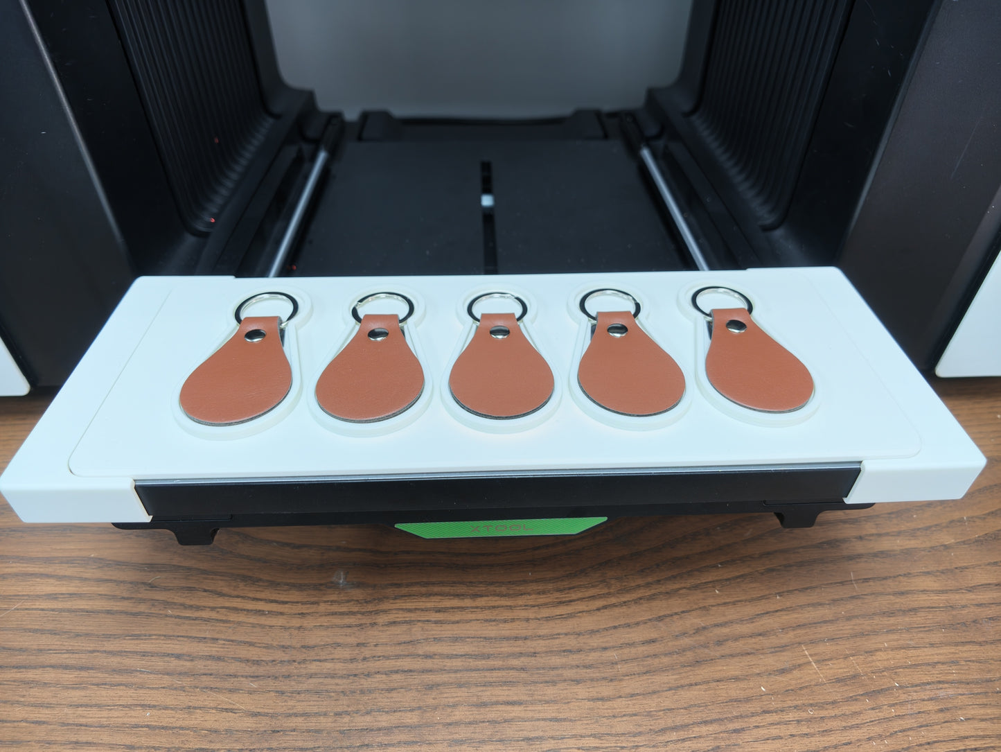 Leather keychain jig for xTool O1 Omni UV printer holding 5 leather keychains