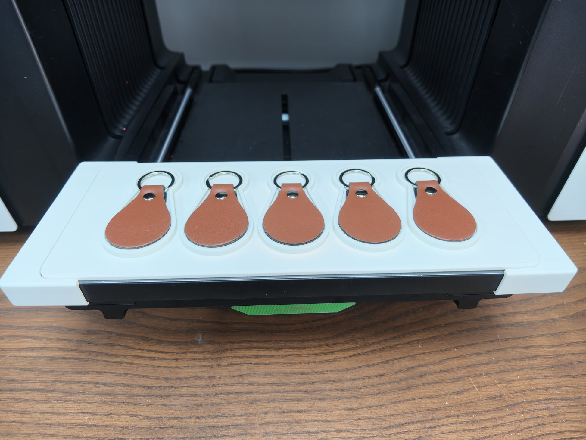 Leather keychain jig for xTool O1 Omni UV printer holding 5 leather keychains