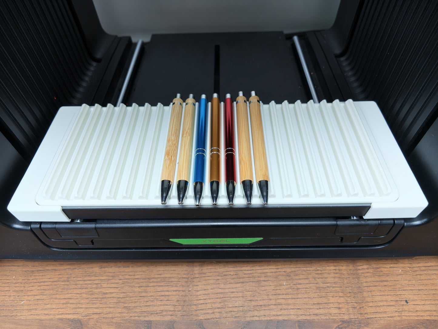 Pen jig for xTool O1 Omni UV printer holding 21 pens ready for batch printing