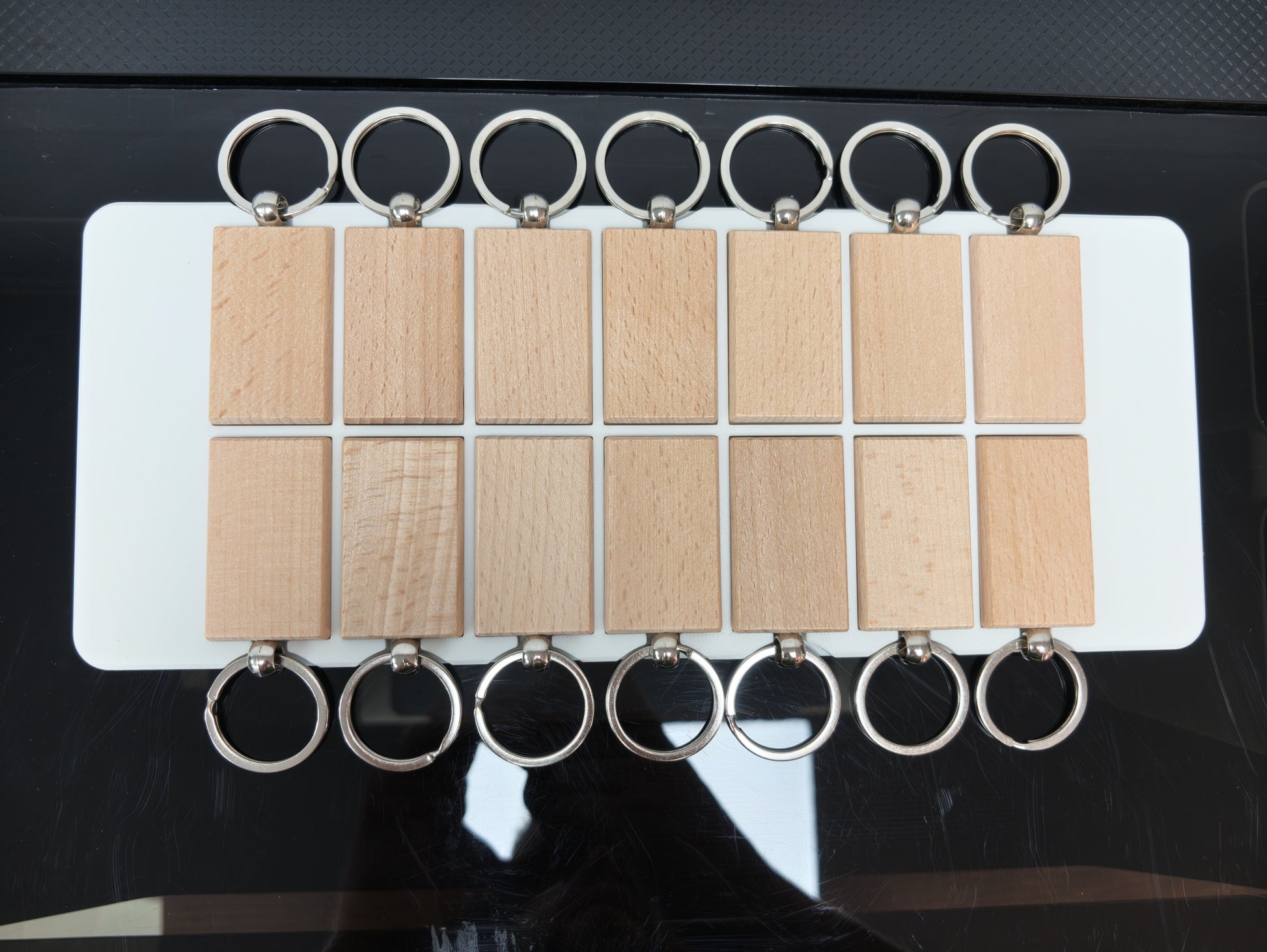 Close up of keychain slots on the L3D rectangular wooden keychain jig for the xTool O1 Omni