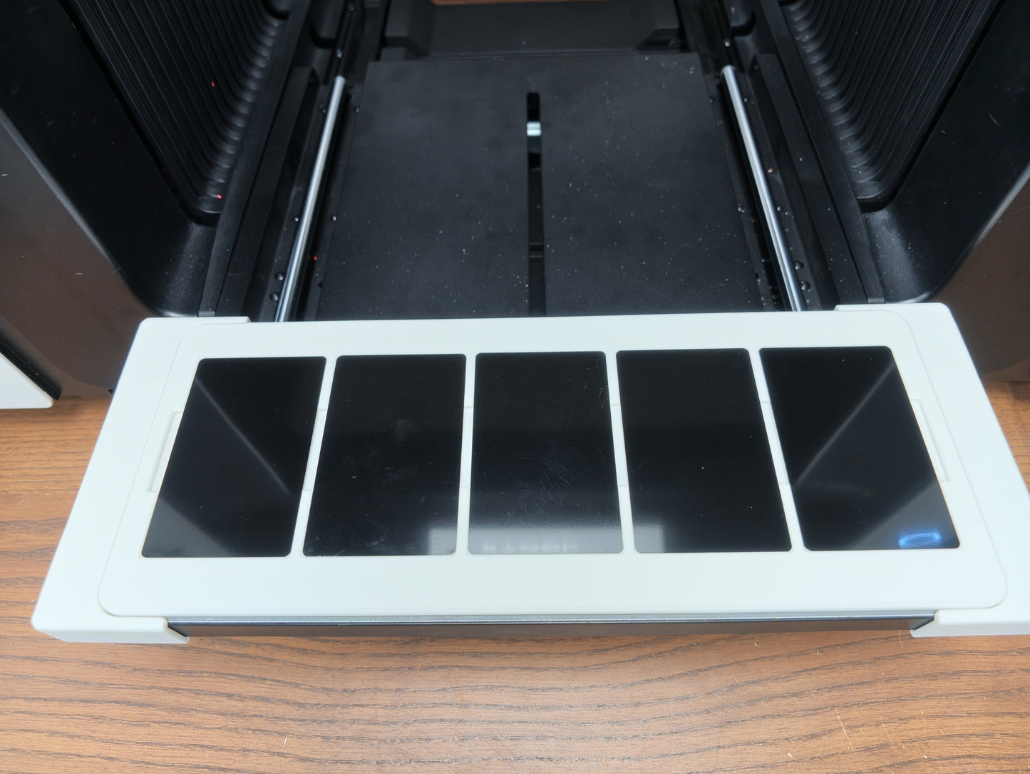 Metal business card jig for the xTool O1 Omni loaded with metal card blanks