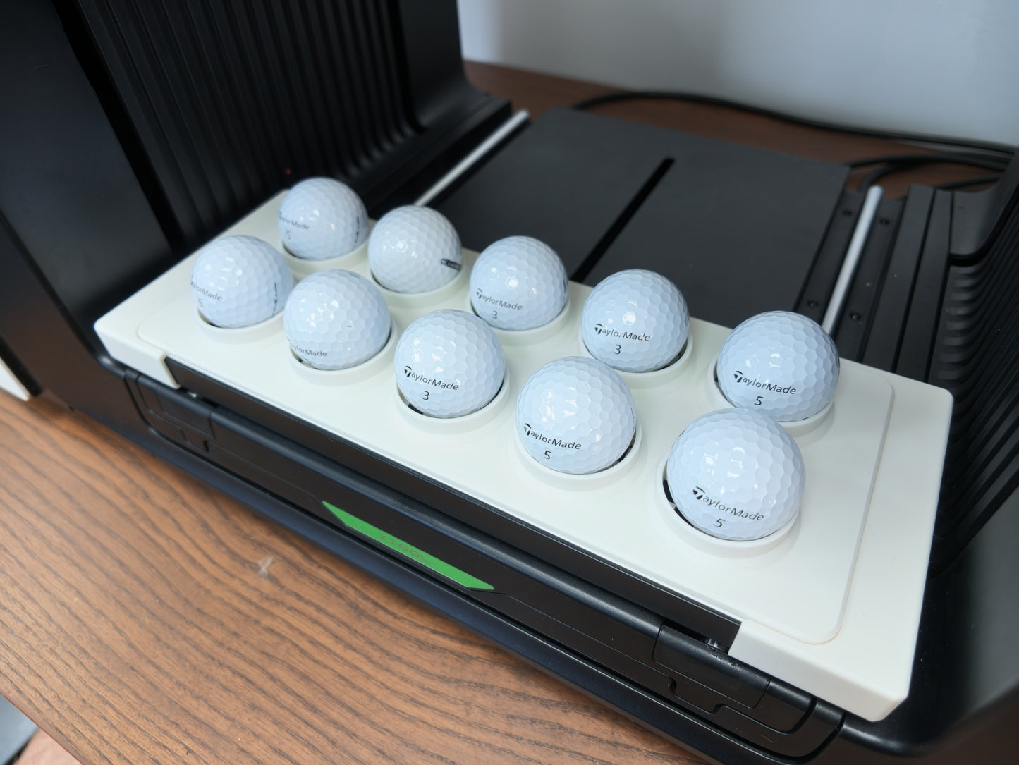 Golf ball jig loaded with balls ready for UV printing on the xTool O1 Omni