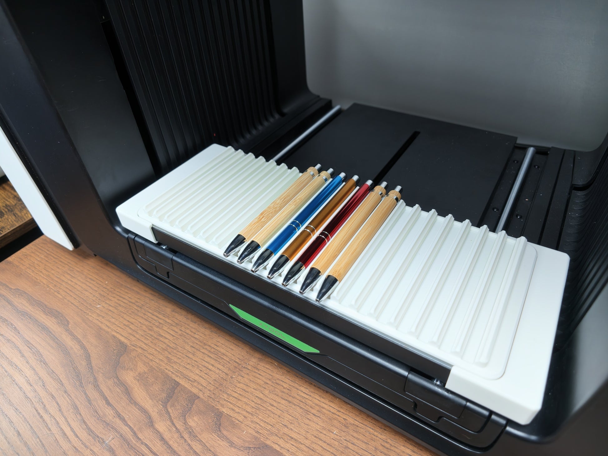 Pen jig loaded with pen blanks on the xTool O1 Omni bed