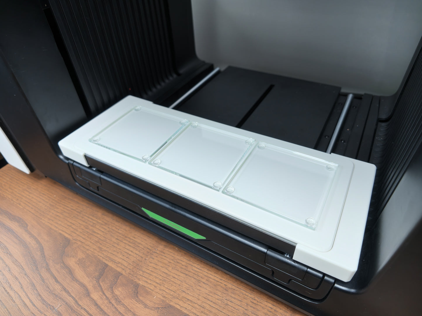Close-up of glass coasters seated in the L3D jig on the xTool O1 Omni bed