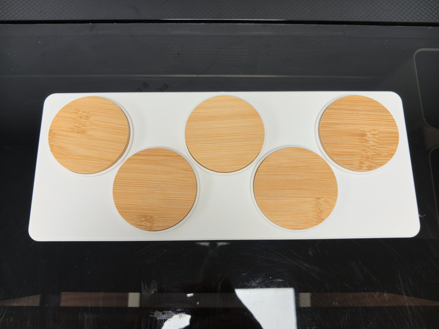 Top-down view of the Round Wooden Bottle Opener Jig loaded with blanks