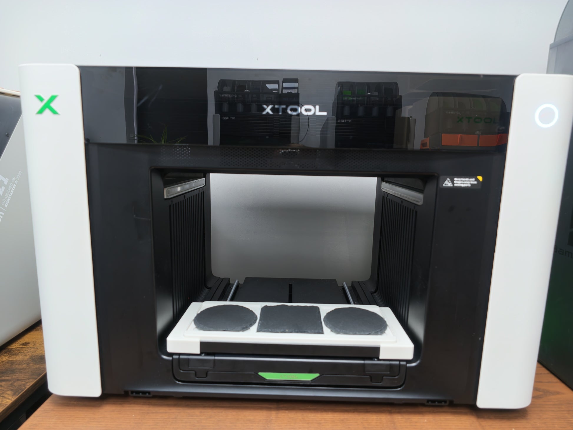 Angled view of the matte white slate coaster jig for the xTool O1 Omni UV printer