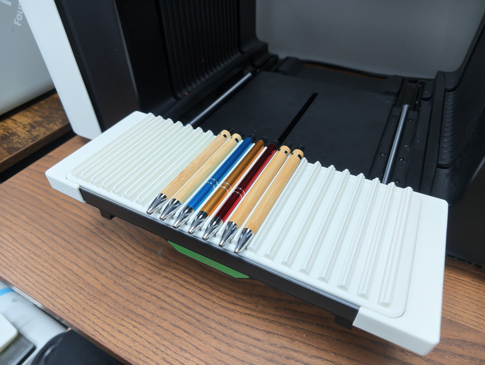 Angled view of the matte white pen jig for the xTool O1 Omni UV printer