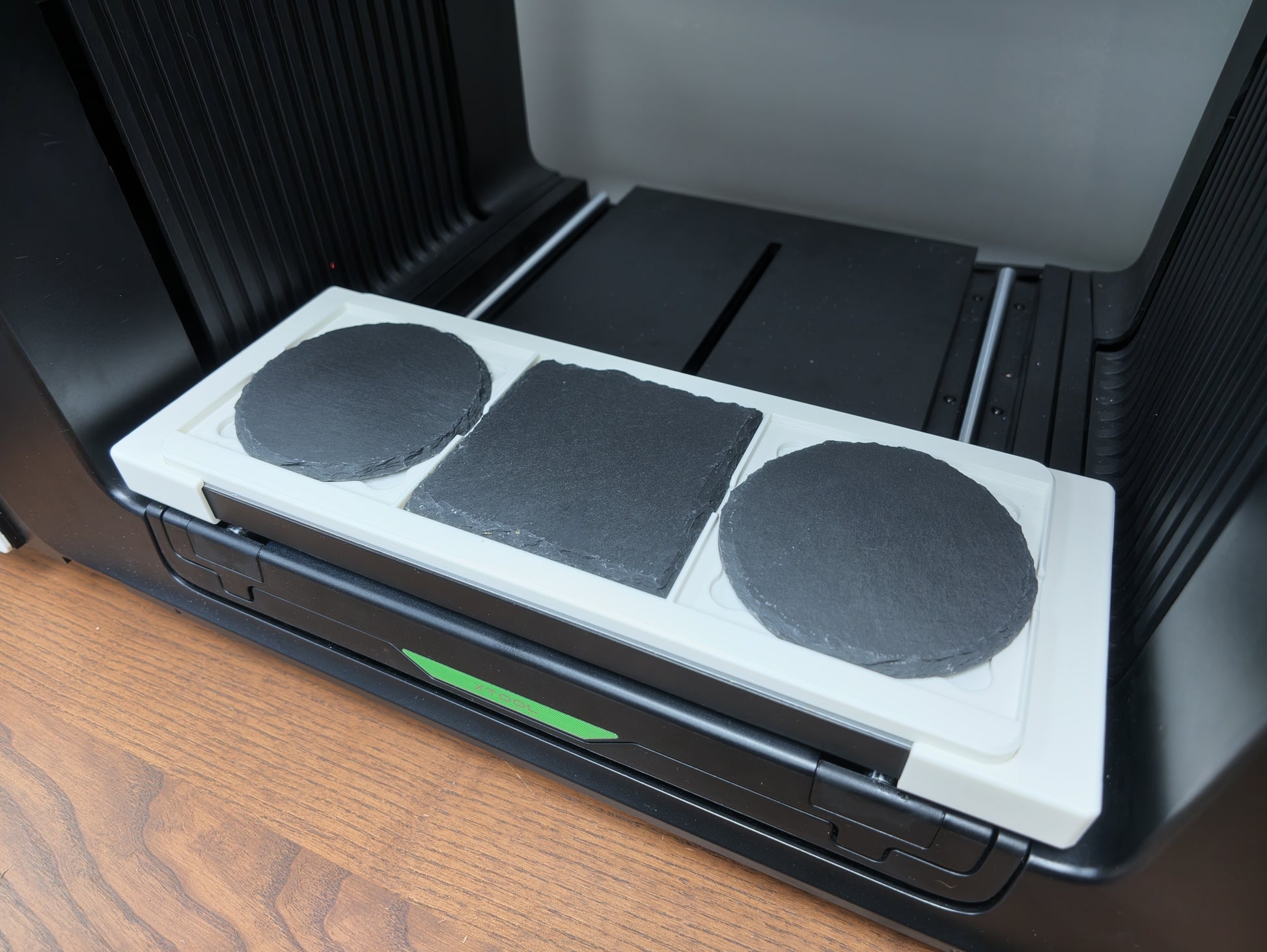 Slate coaster jig detail showing repeatable alignment pockets for xTool O1 Omni printing