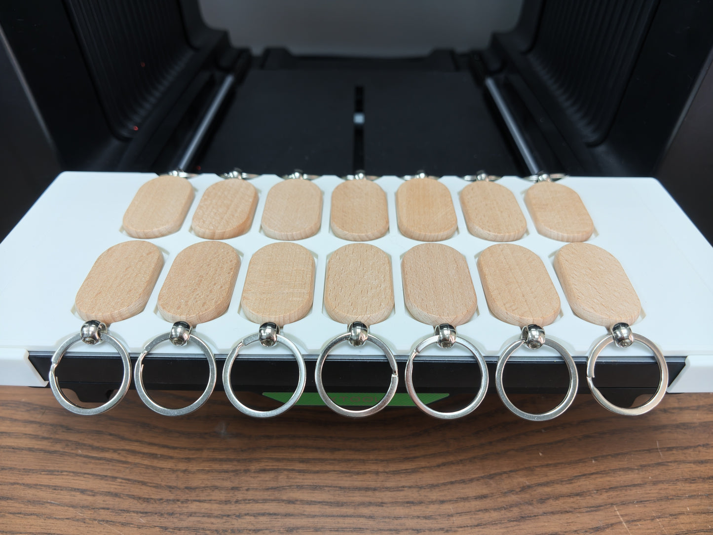 Oval wooden keychain jig installed in the Omni Bracket System on an xTool O1 Omni