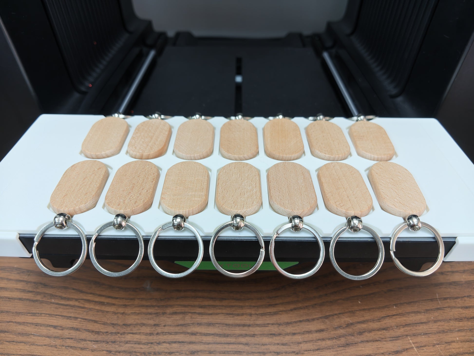 Oval wooden keychain jig installed in the Omni Bracket System on an xTool O1 Omni