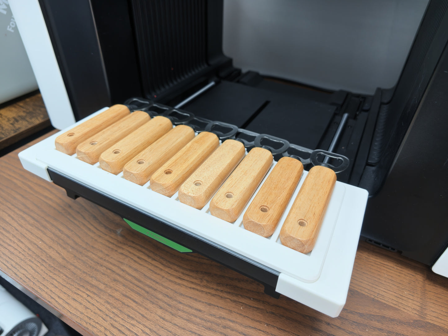 Bottle opener jig detail showing repeatable alignment pockets for xTool O1 Omni printing
