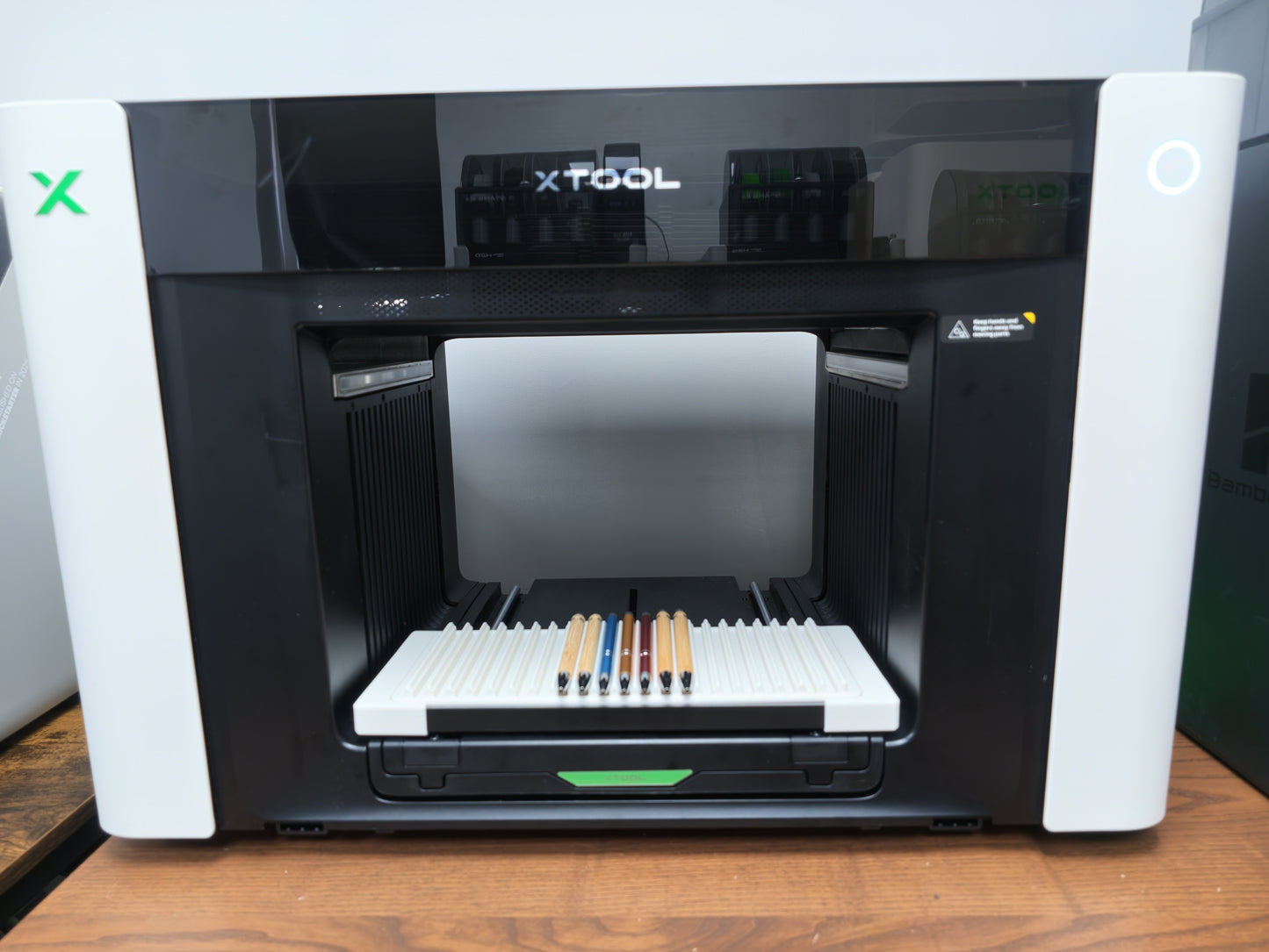 Pen jig detail showing repeatable alignment slots for xTool O1 Omni printing