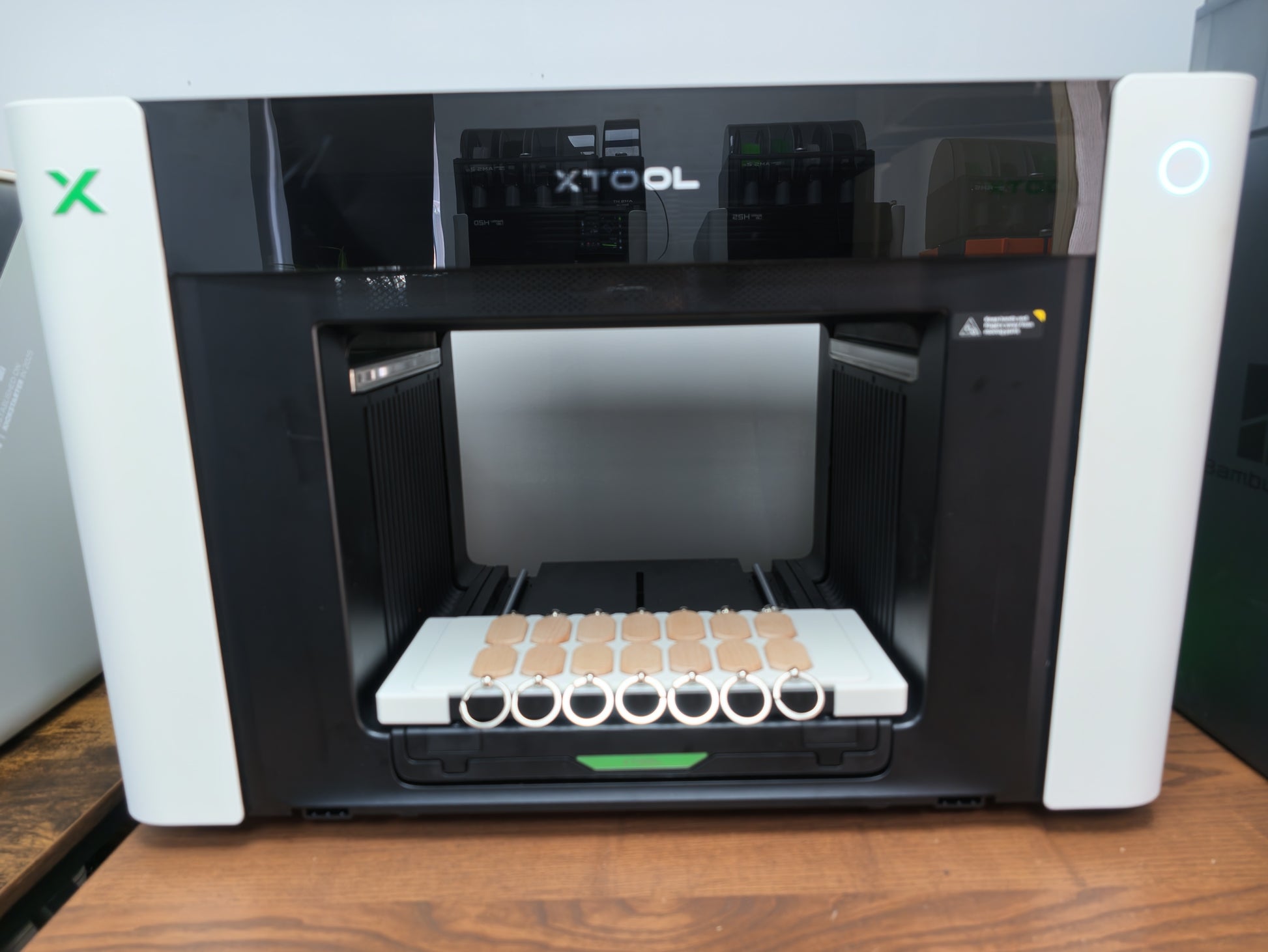 UV printed oval wooden keychains in the L3D jig on the xTool O1 Omni