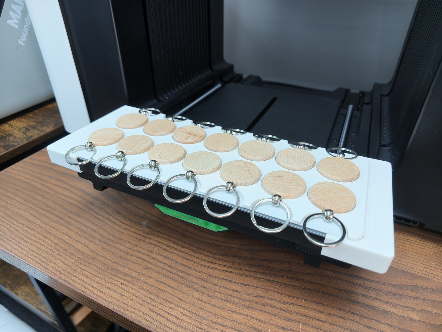 Round wooden keychain blanks positioned in the jig for the xTool O1 Omni
