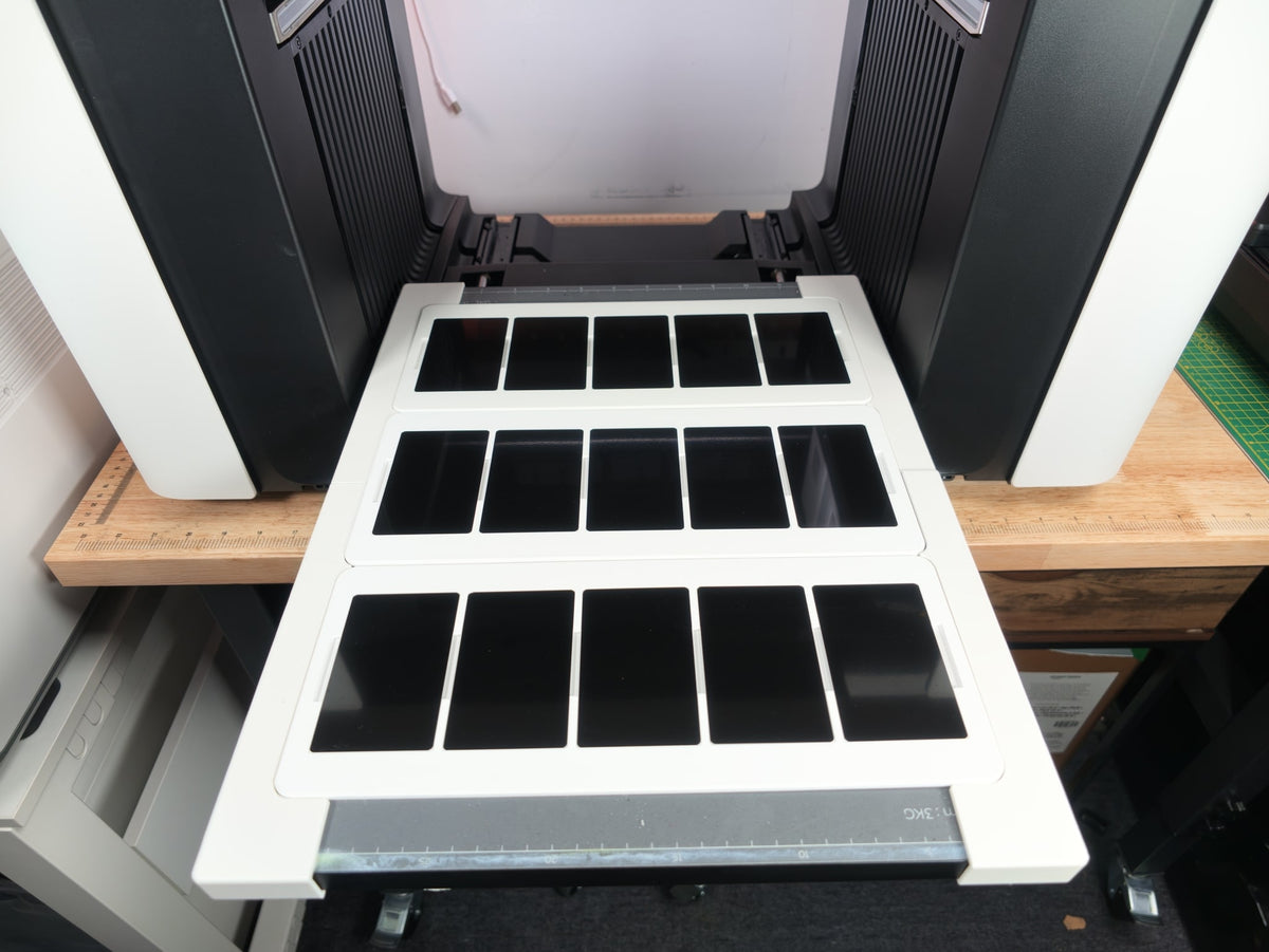 Omni Bracket System XL holding three L3D business card jigs with 15 metal business cards on the xTool O1 Omni