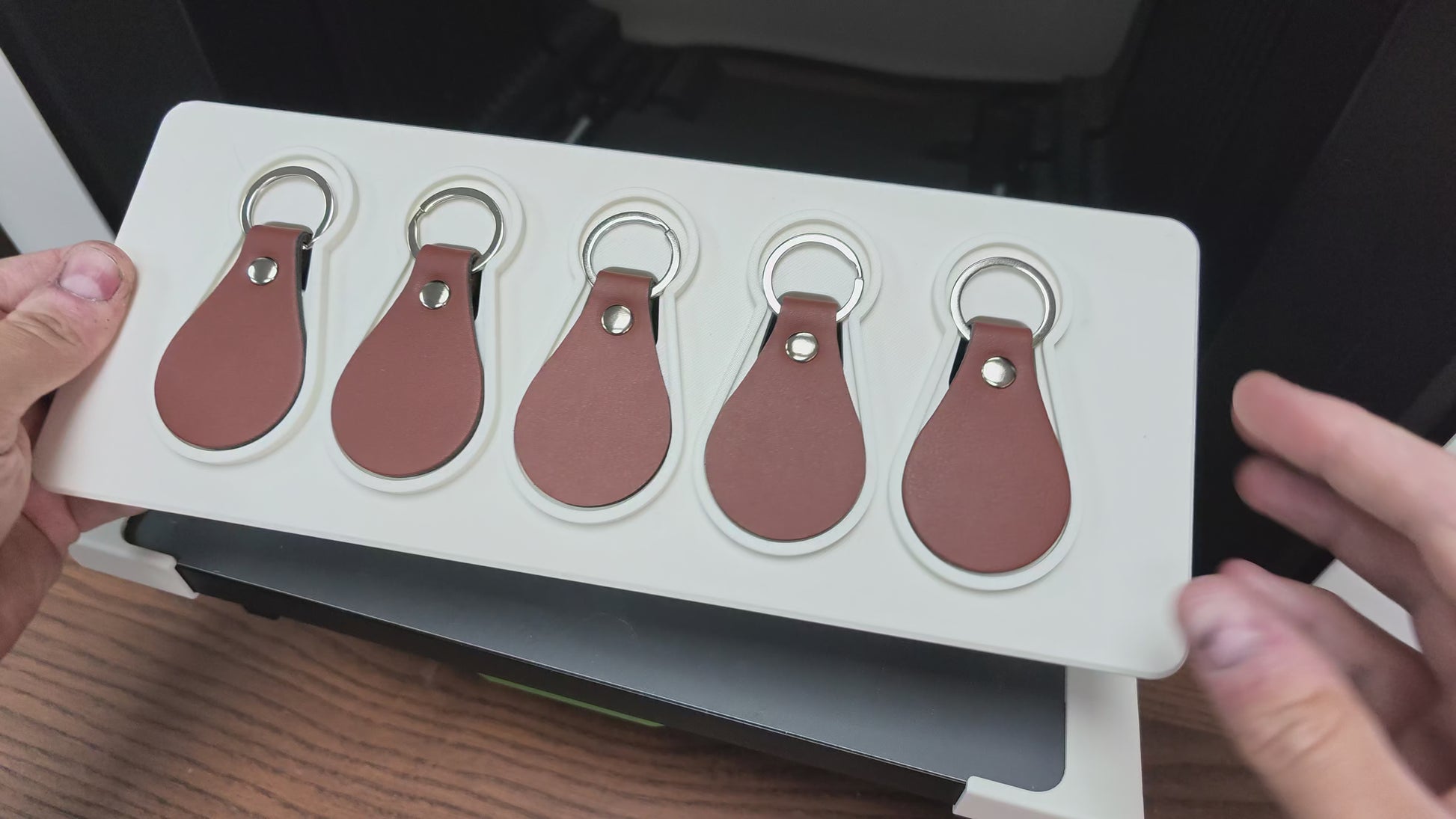Leather keychain jig in action on the xTool O1 Omni UV printer