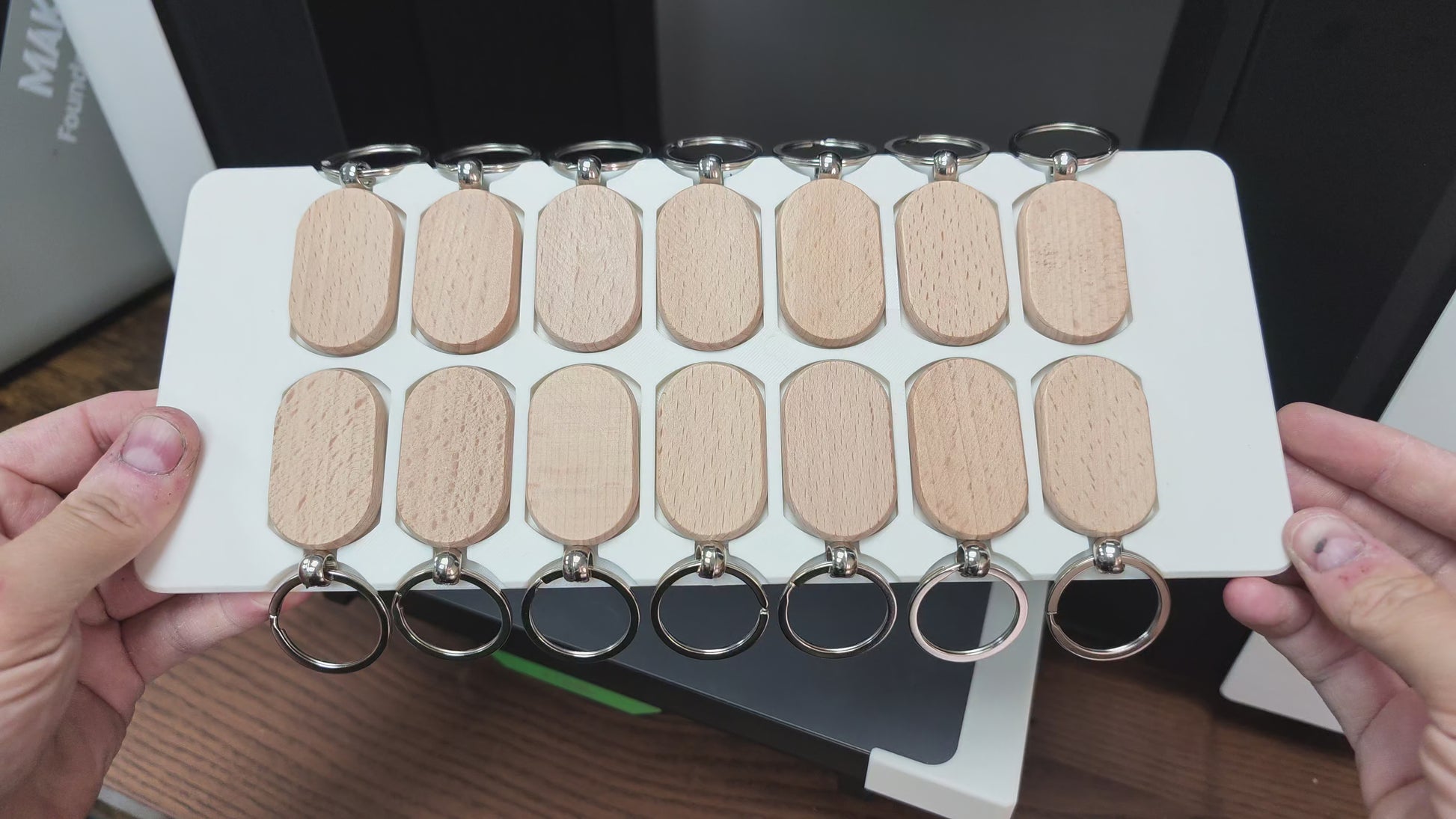 Oval wooden keychain jig in action on the xTool O1 Omni UV printer