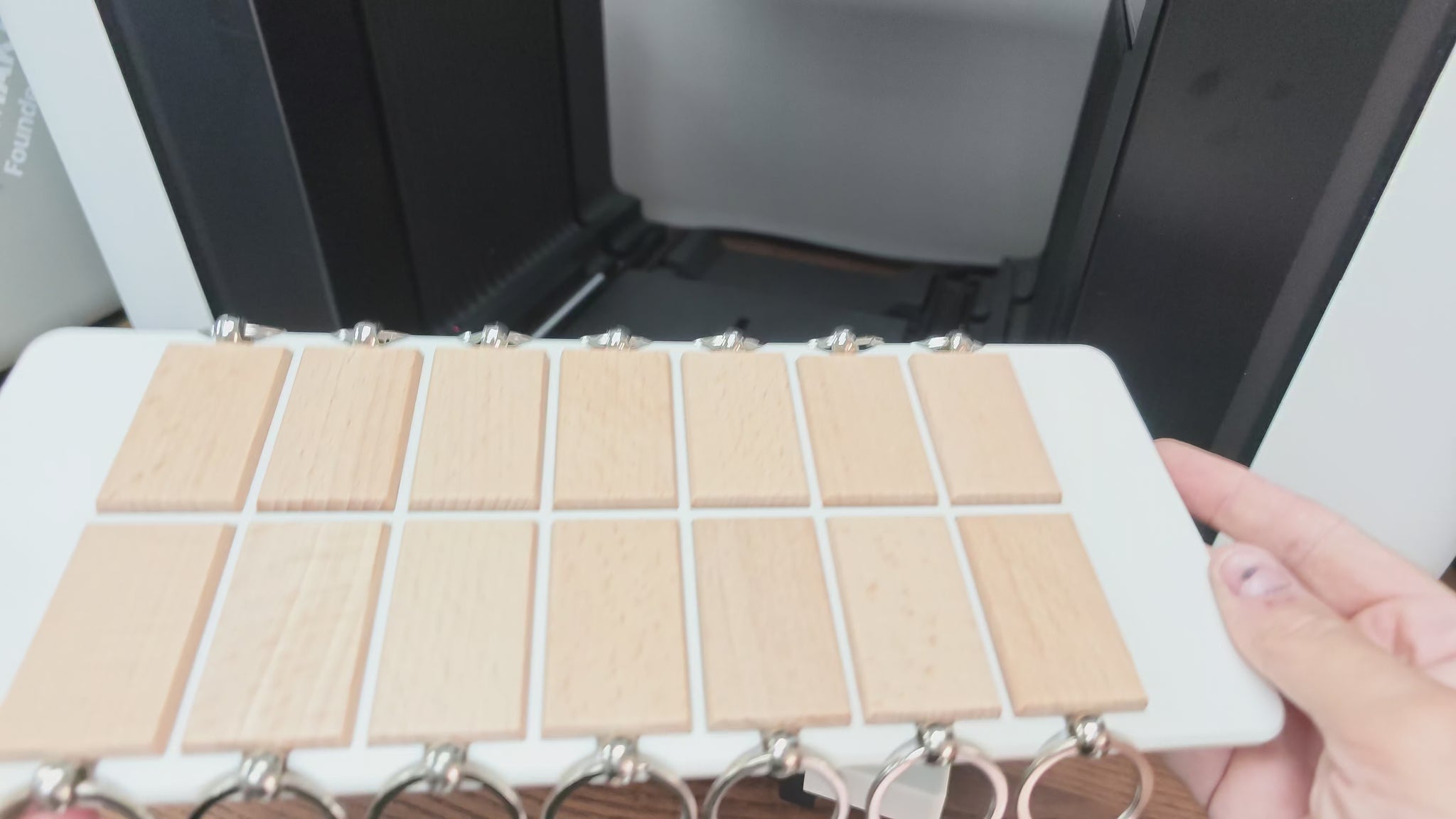 Video of the rectangular wooden keychain jig in use on the xTool O1 Omni UV printer