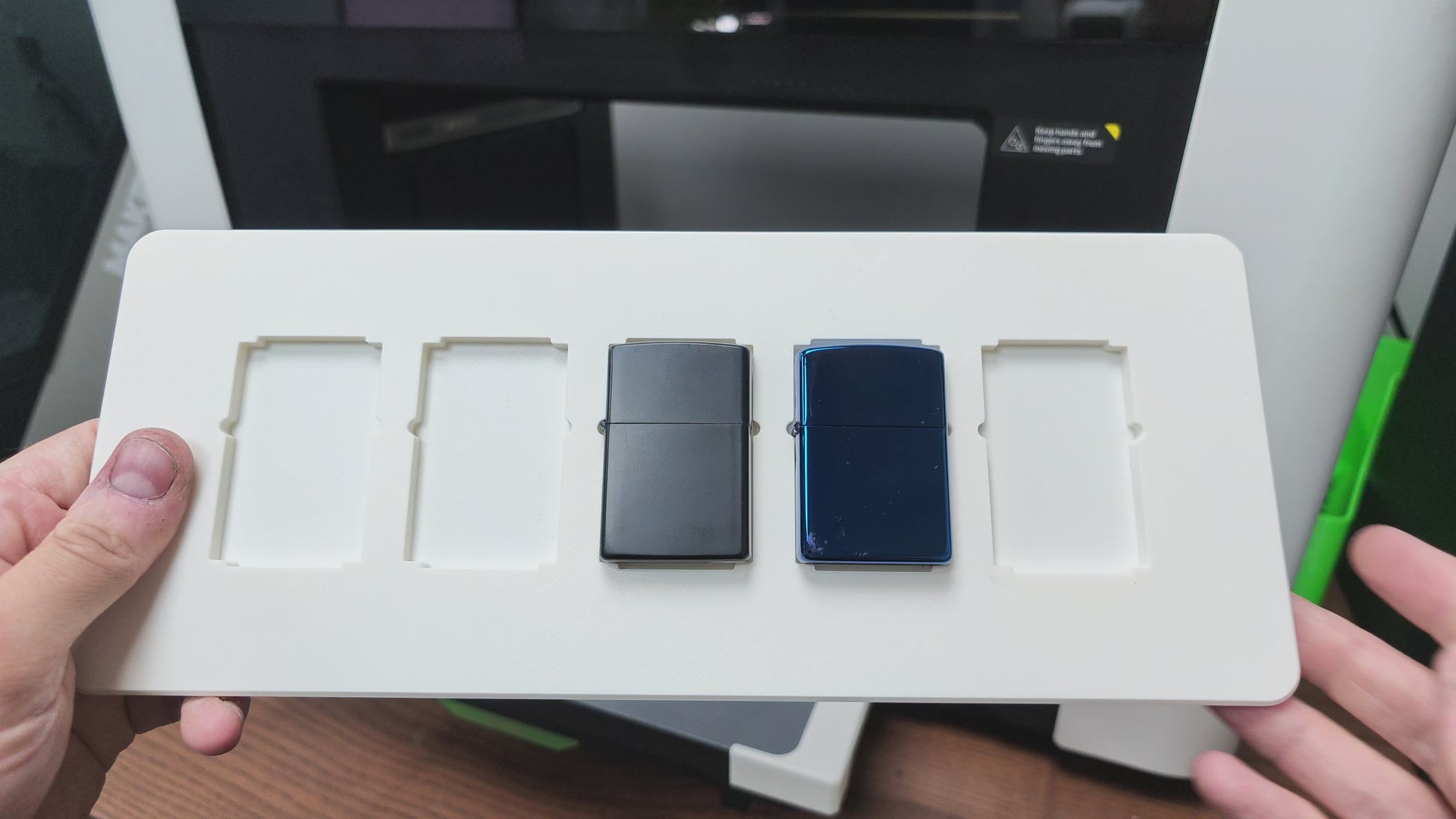 Video of the flip lighter jig batch printing Zippo-style lighters on the xTool O1 Omni