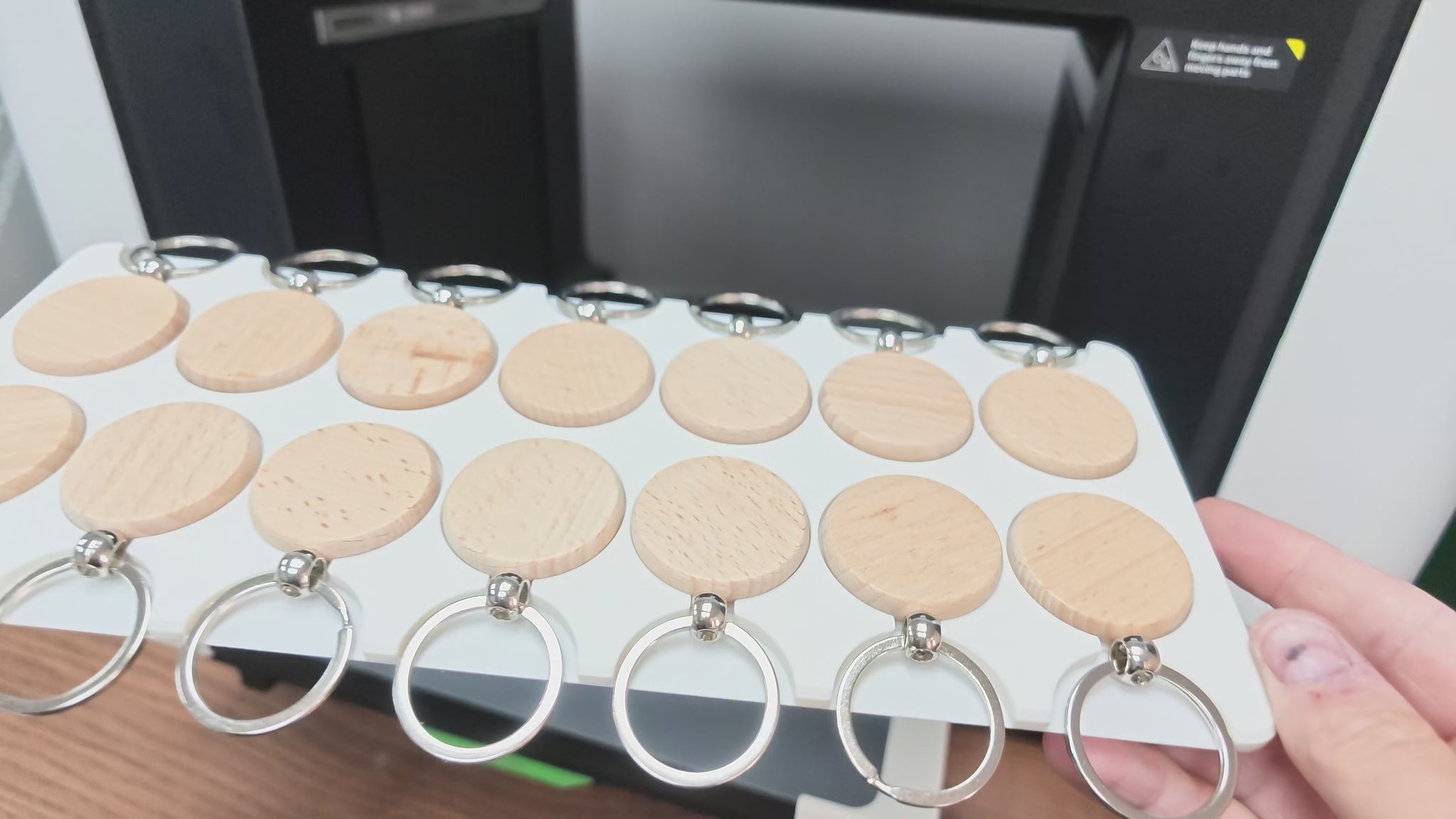 Video of the round wooden keychain jig in use on the xTool O1 Omni UV printer